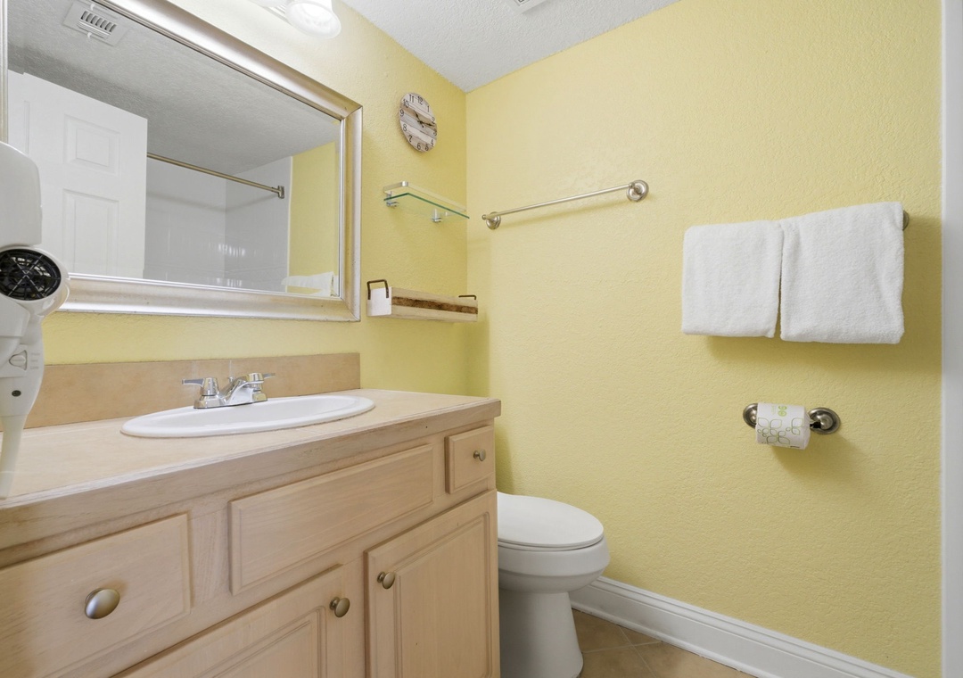Ocean Breeze E601-Step into your private bathroom with warm yellow walls, fresh white towels, and a welcoming vanity with plenty of storage for your belongings.