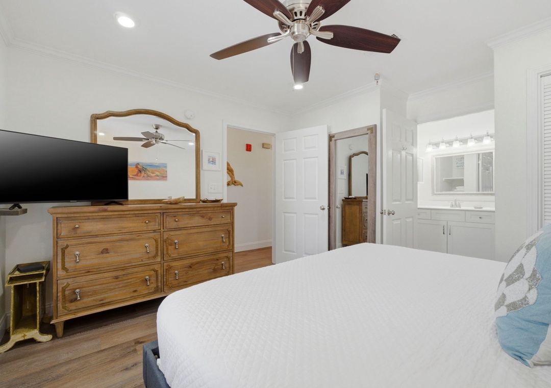 Grand Caribbean 305W- Sink into crisp linens under a gentle ceiling fan, with your private en-suite bath just steps away and entertainment at your fingertips.