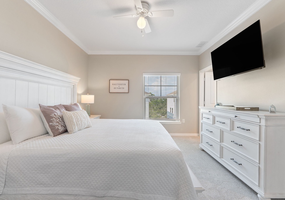 Saltwater & Sunsets- Slip into crisp white linens and let soft coastal light fill your peaceful retreat. This serene bedroom offers plush bedding, a breezy ceiling fan, and plenty of storage in the elegant dresser.