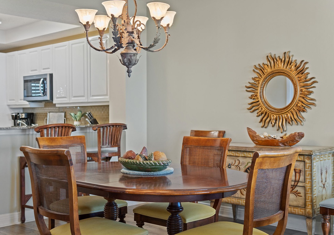 Step into your dining room where warm wood tones and elegant fixtures set the scene for shared meals. The kitchen stands ready nearby, making entertaining effortless.