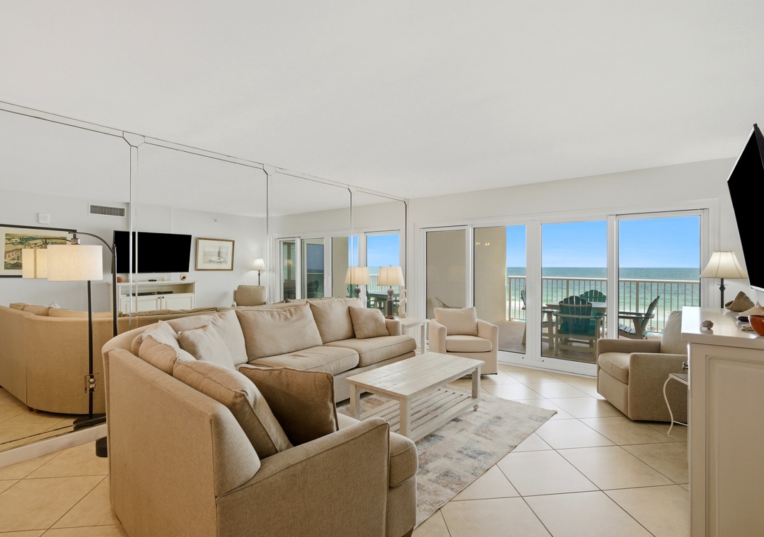 Sandy Key 318- Settle into plush seating in this bright, beachy living space where floor-to-ceiling windows frame stunning ocean views, inviting you to unwind in coastal comfort.