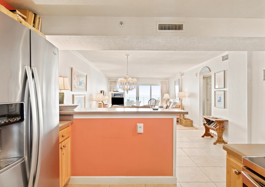 Sandy Key 338- Step into your bright, open kitchen and living space with cheerful coastal accents, stainless appliances, and natural light streaming through to stunning sea views beyond.
