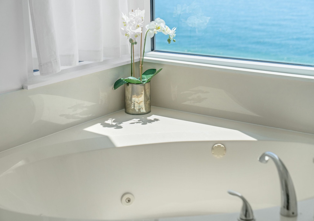 Beach Colony T14B- Slip into your private soaking tub and gaze through the window at the endless turquoise ocean stretching before you—pure bliss awaits.