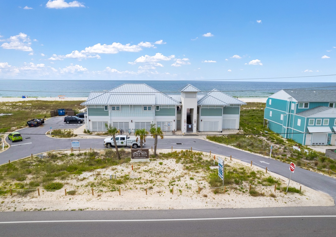The Lost Key Beach Club A coastal vacation property featuring beachfront access and modern architecture, with the Gulf waters and sandy shores framing this serene getaway destination.