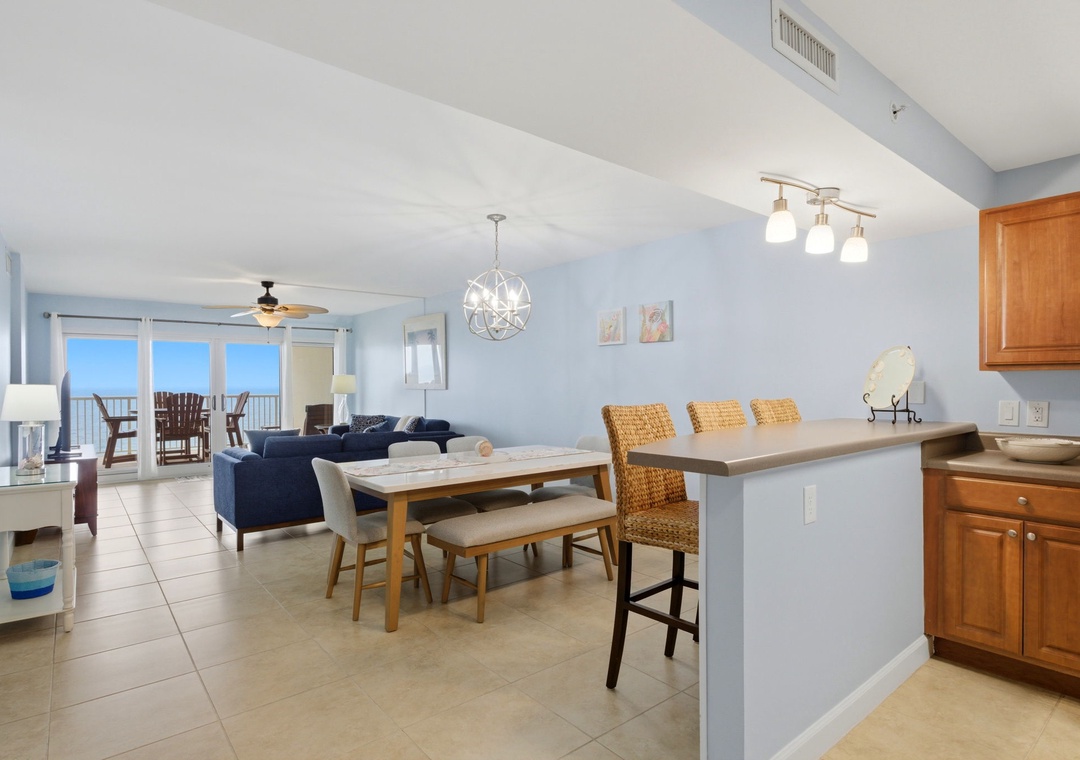 Sandy Key 637- Step into your bright, open-concept space where dining flows seamlessly into the living area, and ocean views greet you through expansive balcony doors—a perfect spot to unwind after a day of coastal adventures.