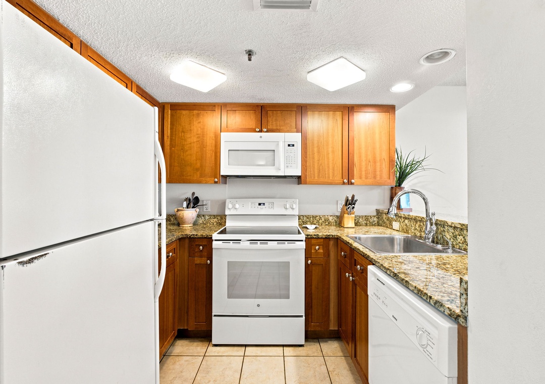 Ocean Breeze W 105- Your fully equipped kitchen makes meal prep a breeze with gleaming granite countertops, warm wood cabinetry, and modern appliances including a microwave and stove—everything you need to cook like you're at home.