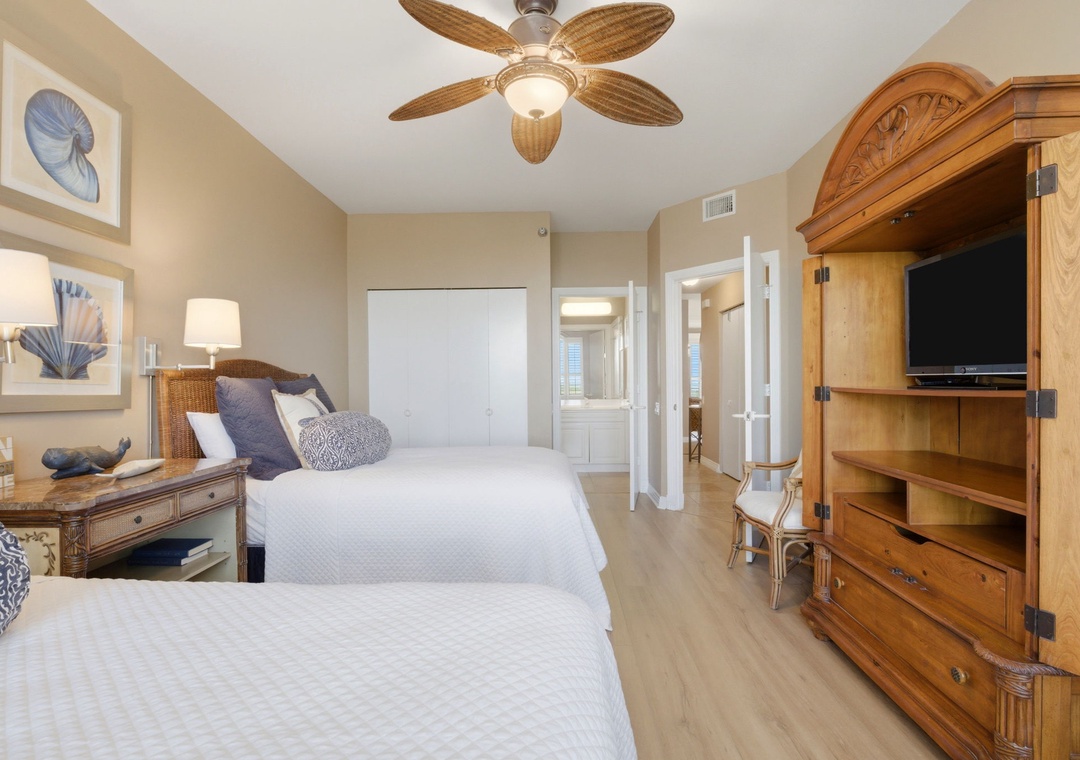 Beach Colony T PH1D-Sink into fresh linens and wake to gentle tropical breezes from your ceiling fan. Two cozy beds, charming coastal décor, and your own entertainment armoire create a peaceful escape.