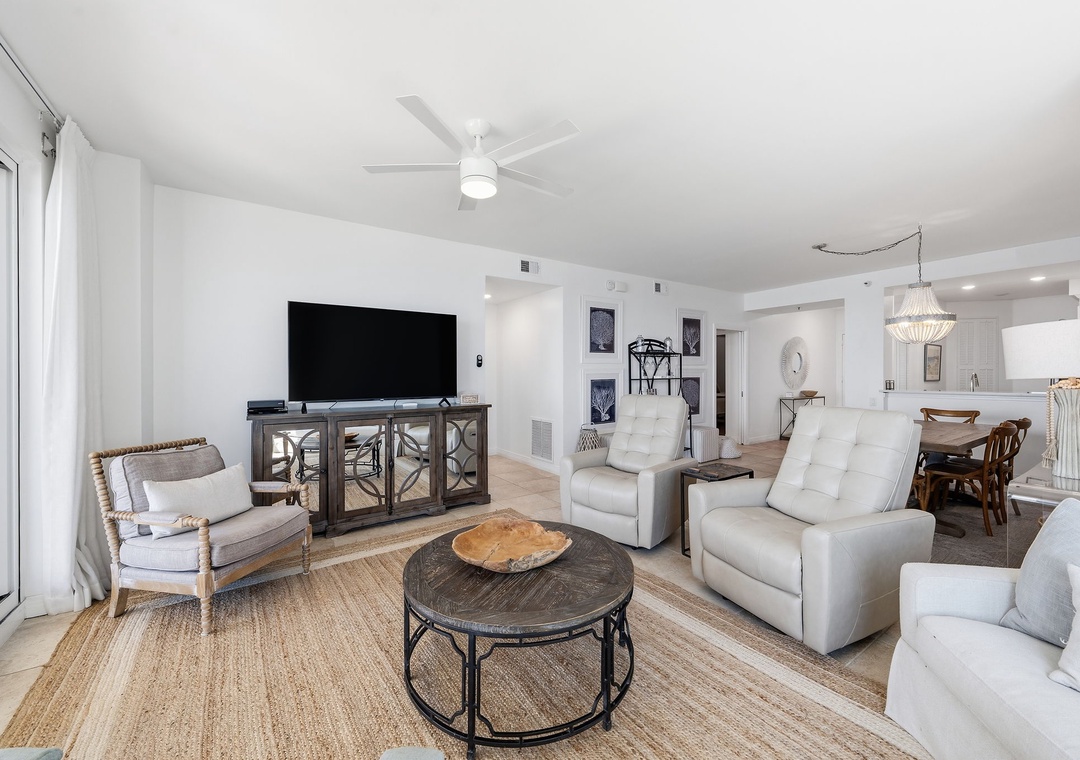 Beach Colony T14B- Relax in your coastal-inspired living room with soft white furnishings, natural textures, and an open flow perfect for gathering with loved ones after a beach day.