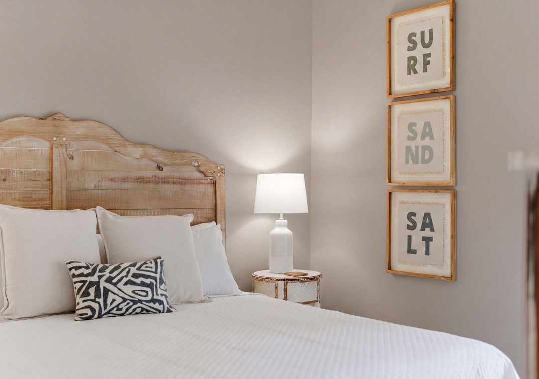 Turtles Nest- Sink into crisp white linens and coastal charm in your bedroom, where driftwood tones and beachy artwork set a serene, restful mood for your getaway.