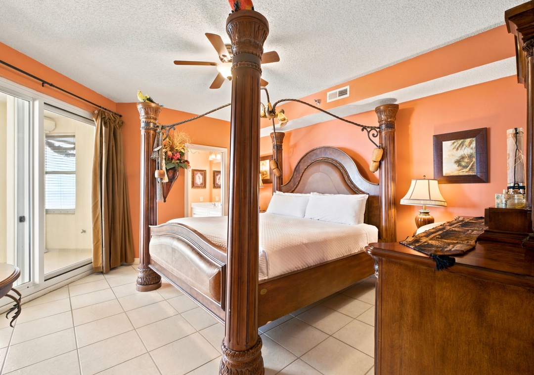 Beach Colony W13A- Your private retreat awaits in this elegantly appointed bedroom with a luxurious four-poster bed, warm tropical decor, and convenient en-suite access for ultimate comfort.