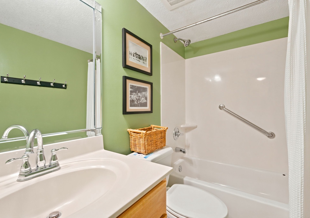 Sandy Key 338- Refresh in your private bathroom with a tub-shower combo, grab bars for safety, and cheerful green walls that brighten your morning routine.