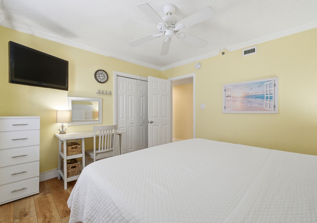 Ocean Breeze E601-Unwind in your sunlit bedroom with soft linens, coastal artwork, and a ceiling fan keeping the air fresh. Everything you need for a restful night awaits.