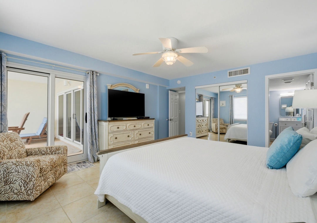 Sandy Key 637- Relax in your spacious coastal bedroom, where calming blue tones, crisp linens, and a private balcony create your perfect beach retreat.