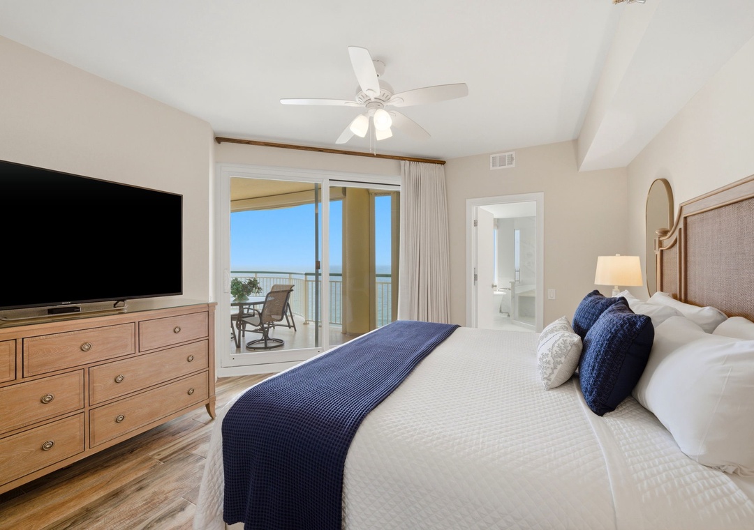 Beach Colony Tower PH1B - Drift off to restful sleep in your coastal bedroom, where crisp white linens invite you to unwind and ocean breezes flow through sliding doors to your private balcony overlooking the water.