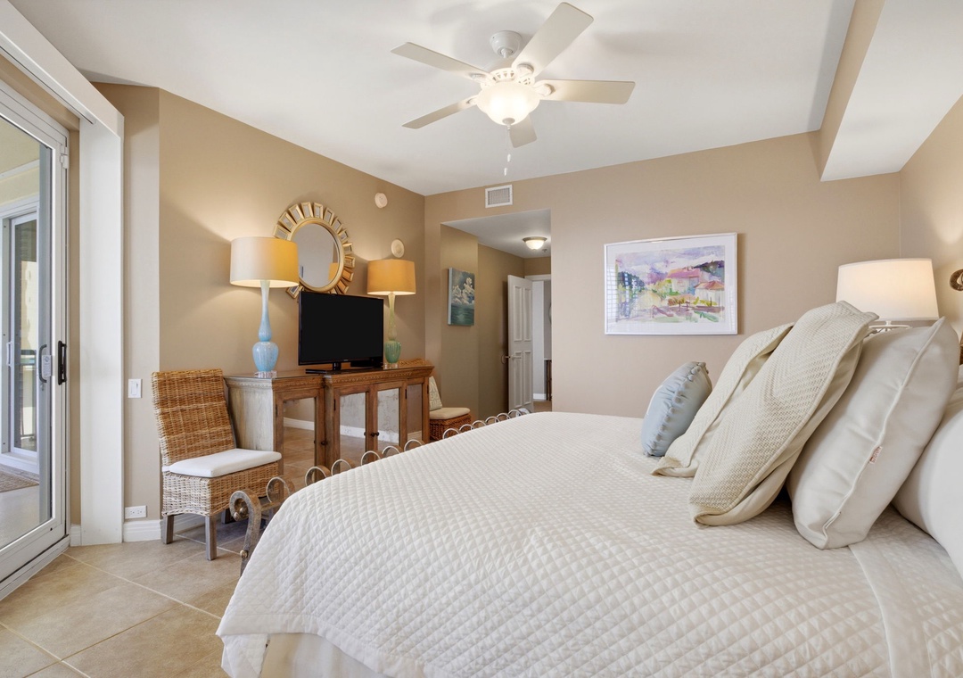 Beach Colony T PH1D- Step into your serene retreat where plush white linens invite restful nights and a private balcony opens to gentle breezes and peaceful views.