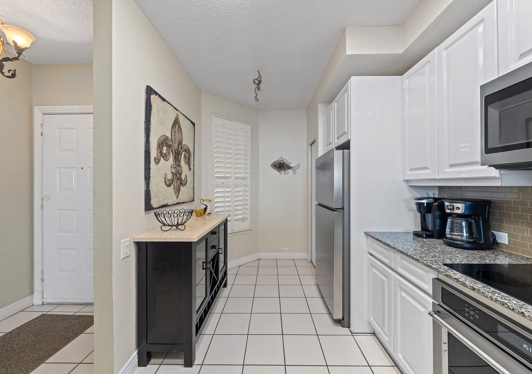 Beach Colony T15B- Your fully equipped kitchen makes it easy to prepare meals at your leisure, with modern appliances, granite countertops, and everything you need for a comfortable stay.