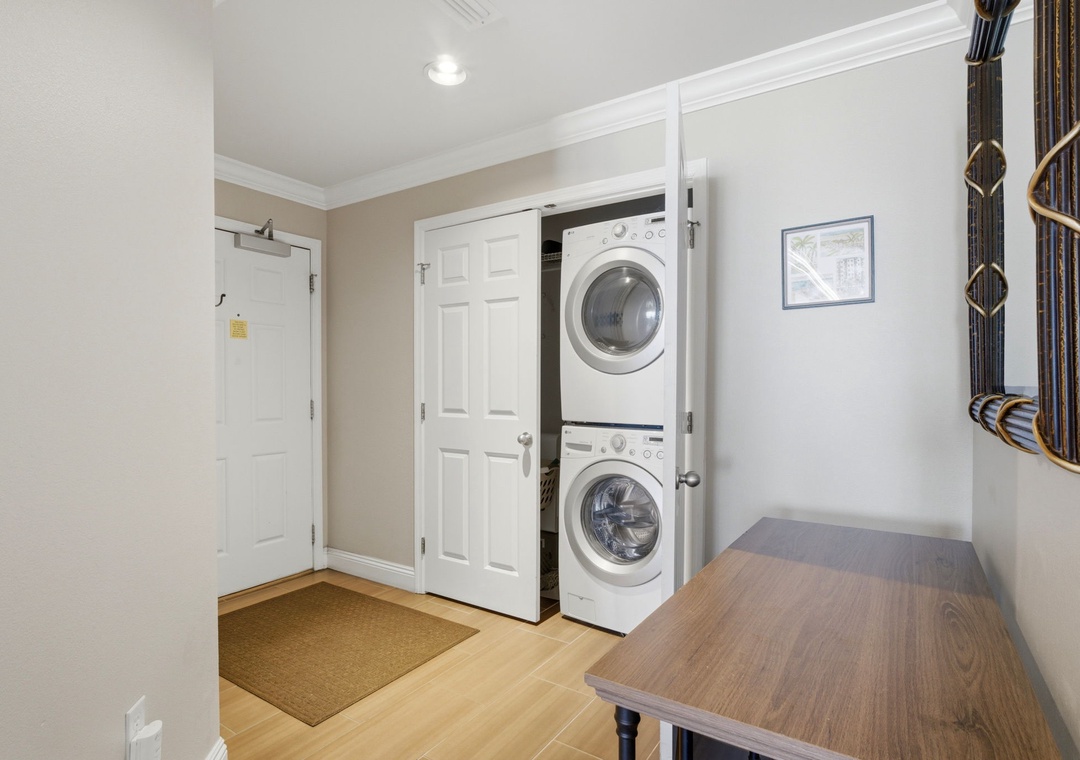 Your entry features convenient in-unit laundry with a stacked washer and dryer tucked neatly in a closet, plus warm hardwood floors throughout.