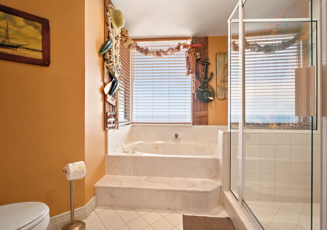 Beach Colony W13A- Step into a serene coastal escape with a spacious soaking tub, separate glass shower, and charming nautical touches that invite you to relax after your beach adventures.