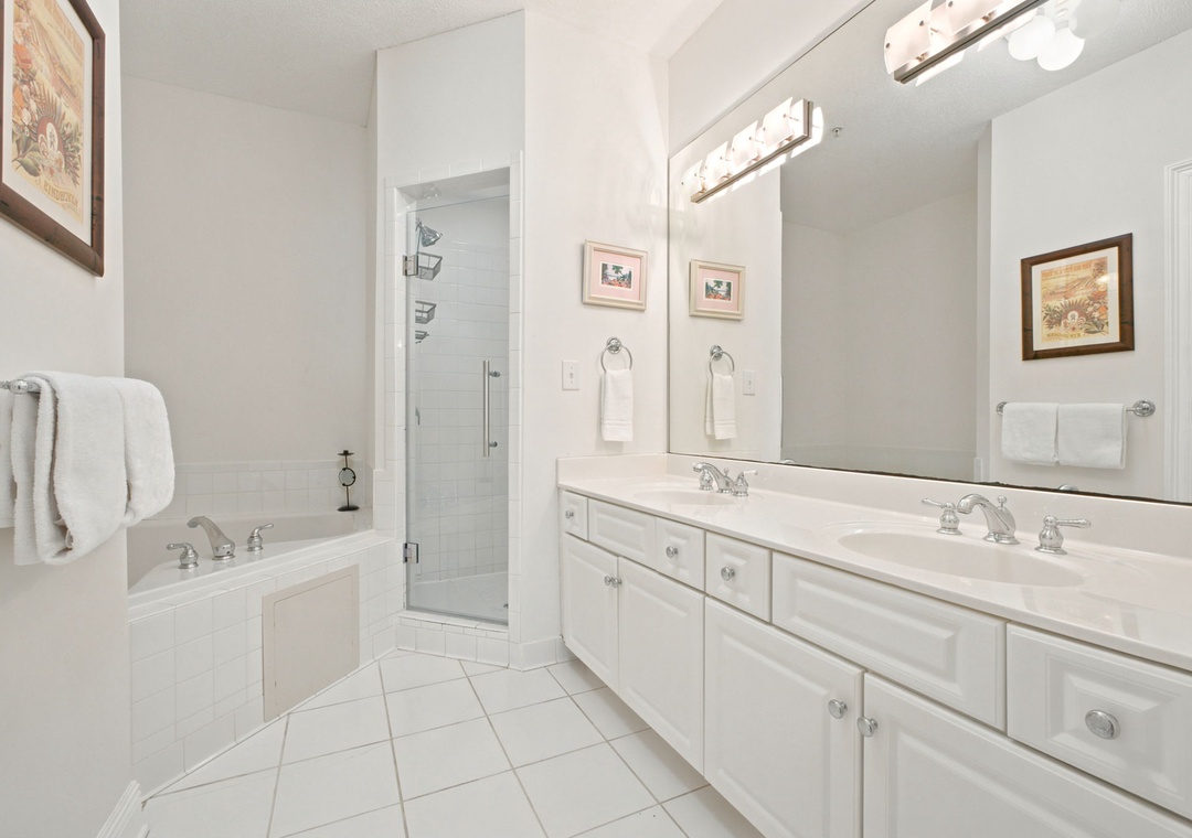 Step into your bright, pristine bathroom featuring a soaking tub, walk-in shower, and dual vanity—your personal spa awaits after a day of exploration.