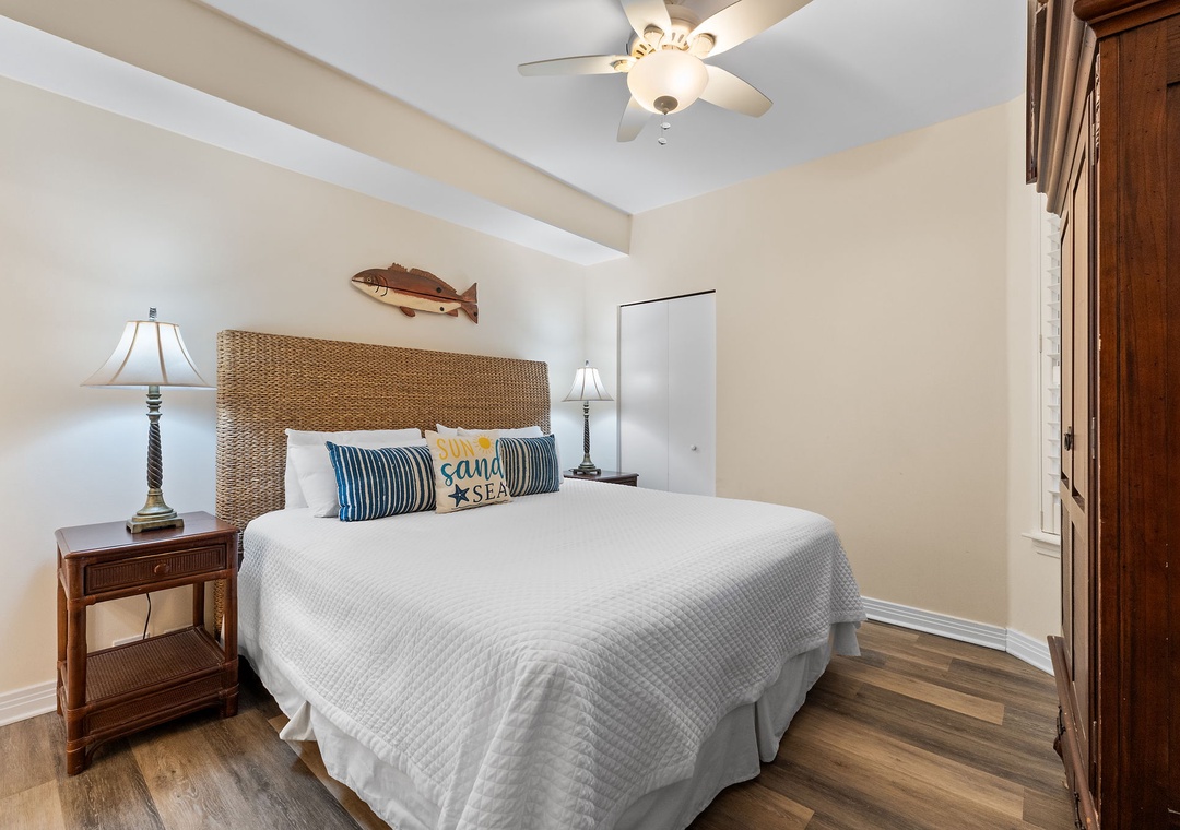 Beach Colony Tower 10C- Sink into the crisp white linens and drift off under the gentle ceiling fan in your coastal-themed bedroom, where woven textures and warm woods create your personal seaside retreat.