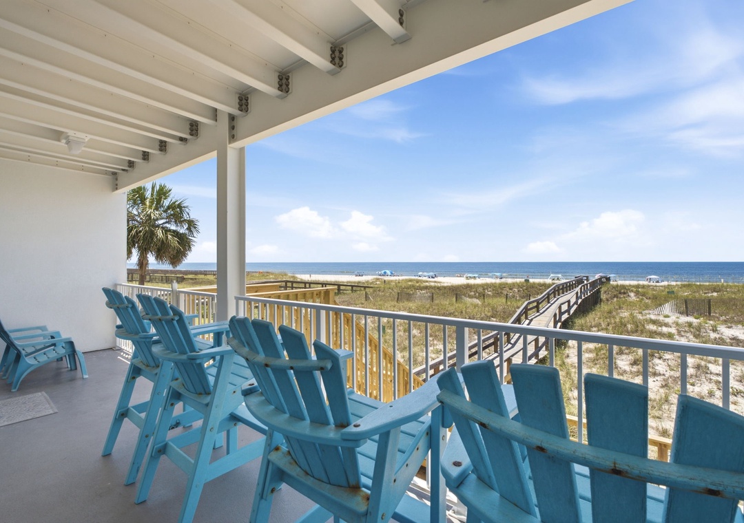 Picture yourself relaxing in this spacious beachfront retreat, where turquoise lounge chairs await and sweeping ocean views stretch endlessly before you. Your private beach boardwalk access makes sandy toes just steps away.