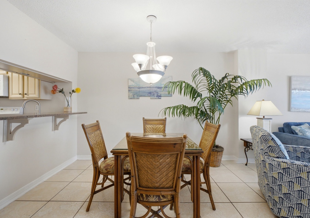 Ocean Breeze E702- Picture yourself gathered around this inviting dining table, where natural light and coastal charm create the perfect spot for morning coffee or evening meals with your travel companions.