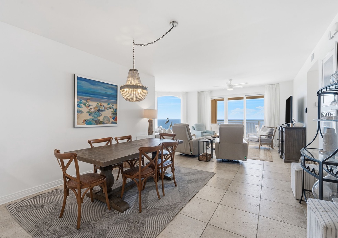 Beach Colony T14B- Bright, airy living and dining space where you'll love gathering for meals and relaxing. Notice the stunning ocean view through those expansive windows—your perfect backdrop for every moment here.