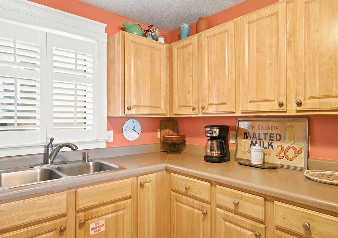 Sandy Key 338- Step into a cheerful kitchen where warm coral walls complement natural wood cabinetry. Morning coffee awaits with everything you need to start your day right in this fully-equipped space.