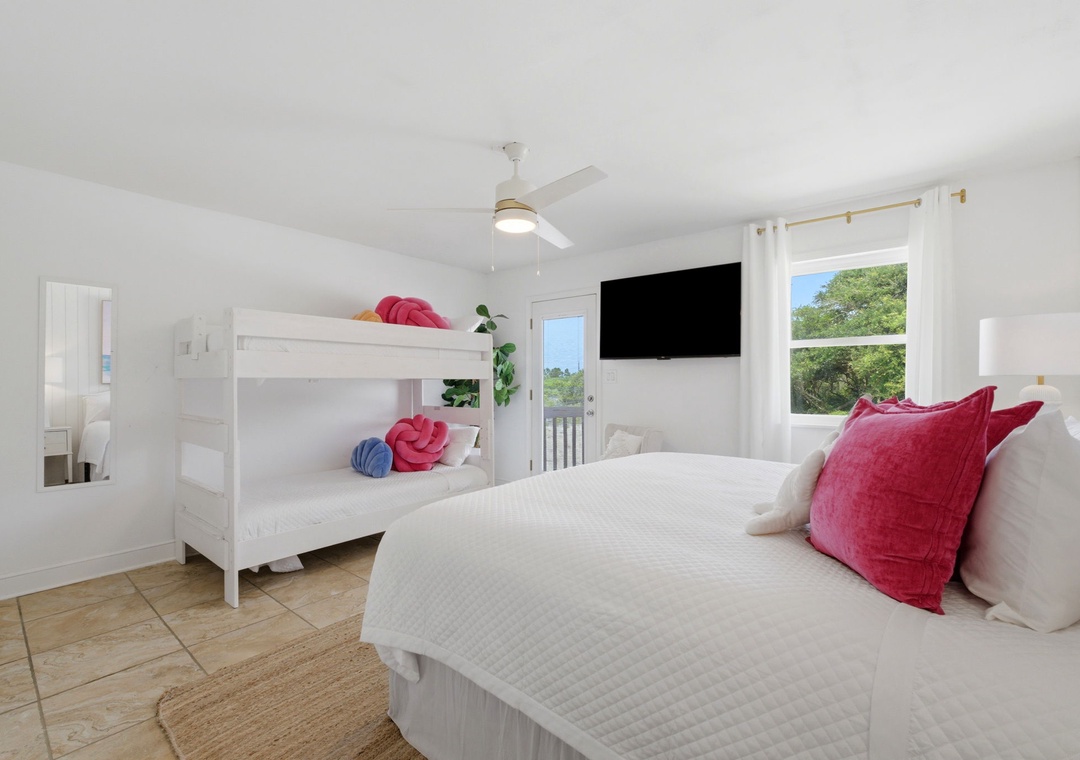 North Lost Key Landing B2- Settle into your bright, airy bedroom where a plush queen bed and fun bunk beds provide comfort for the whole family, plus a TV and private balcony access.
