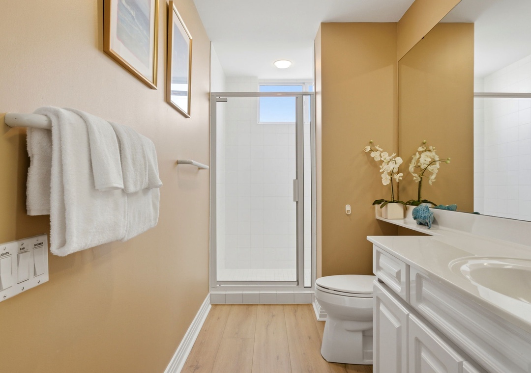 Beach Colony T PH1D-Your private bathroom features a spacious walk-in shower, fresh towels, and calming neutral tones that create a serene retreat after a long day of exploring.