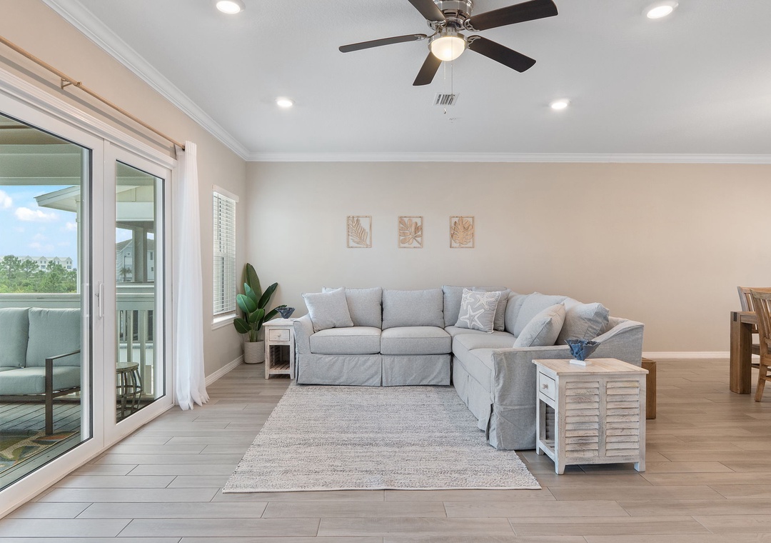 Saltwater & Sunsets- Relax in your bright, open living space with cool tile floors, a ceiling fan overhead, and sliding glass doors opening to your private balcony.