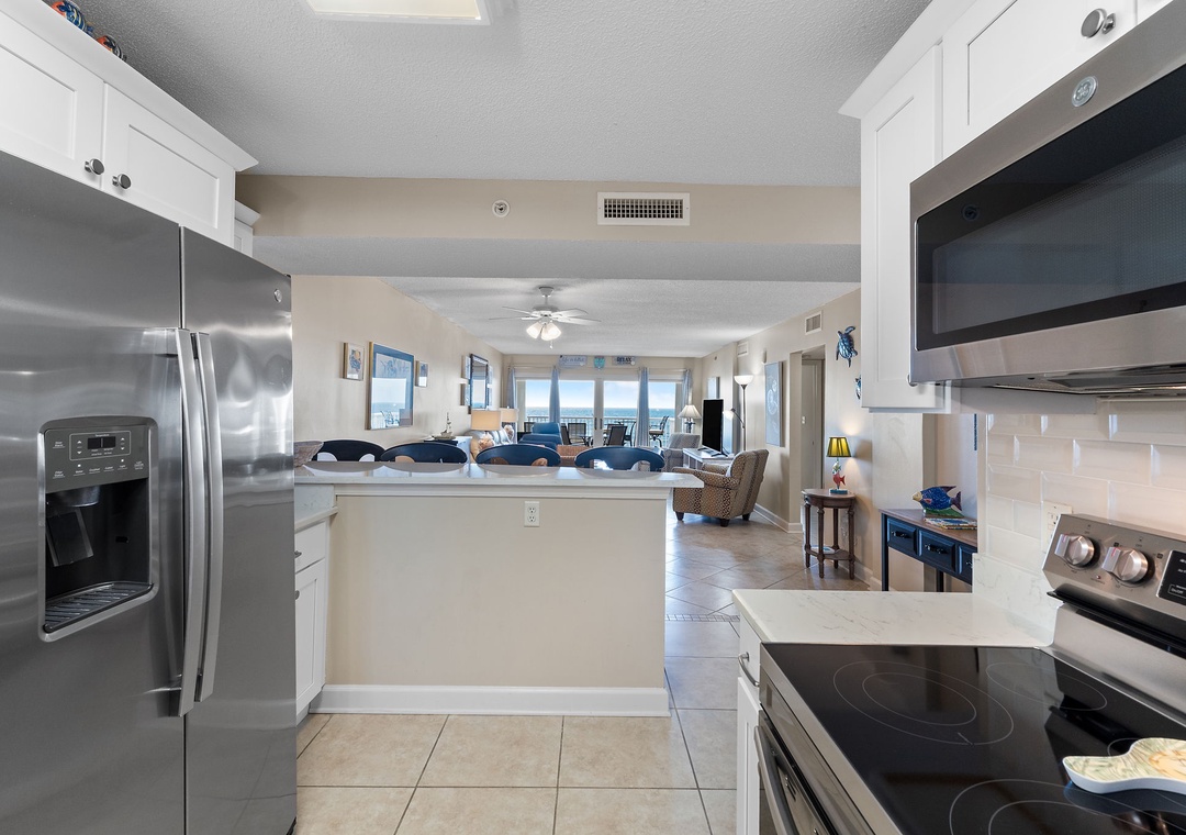Sandy Key 628- Your open-concept kitchen flows seamlessly into the living area, with stainless steel appliances and a bright, welcoming layout perfect for gathering while ocean views shimmer beyond.