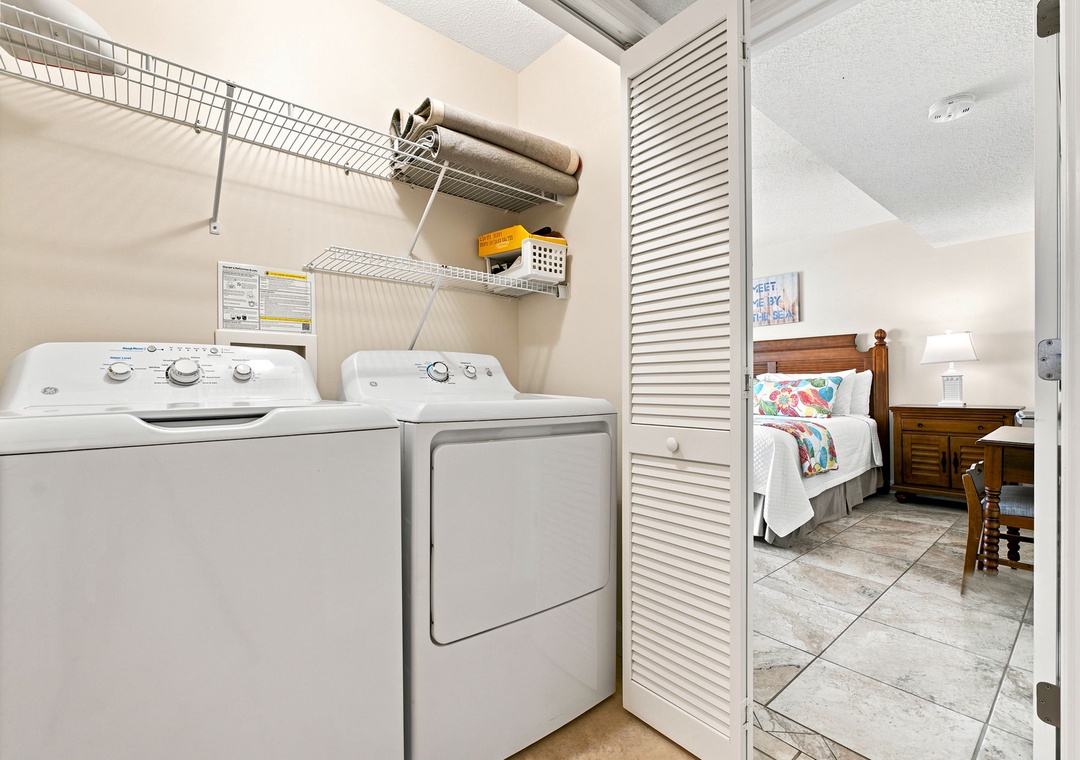 Sandy Key 411- Your own full-size washer and dryer keep clothes fresh, while shelving above stores beach towels and essentials—just steps from your cozy bedroom retreat.
