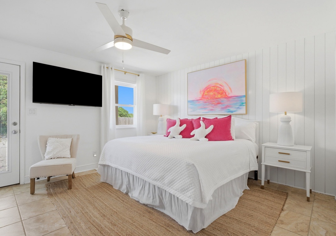 North Lost Key Landing B2- Step into your serene coastal retreat with crisp white linens, cheerful pops of pink, and artwork that captures the ocean's warmth—your perfect haven for rest and renewal.