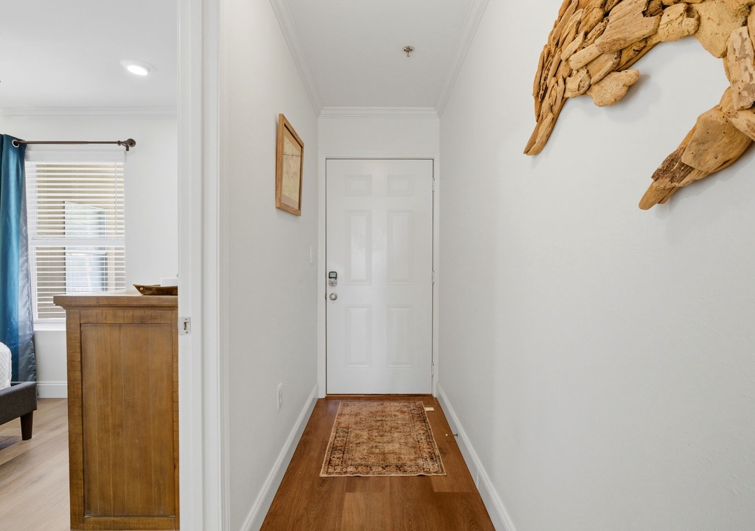 Grand Caribbean 305W- Bright, welcoming entryway featuring coastal-inspired driftwood art and warm hardwood floors that greet you the moment you arrive.
