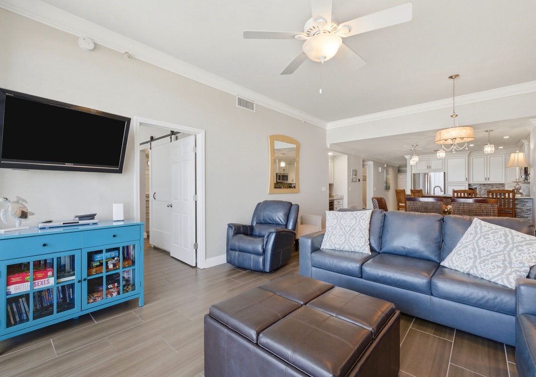 Unwind on plush leather seating in your spacious living room, where a wall-mounted TV invites cozy movie nights and an open layout flows into a fully-equipped kitchen.
