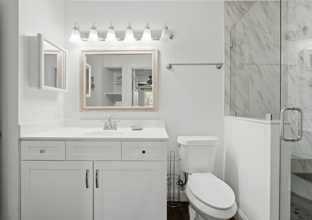 Grand Caribbean 305W- Step into your bright, spotless bathroom with clean lines and calming marble. You'll love the modern glass shower and gleaming white surfaces—perfect for unwinding after exploring the area.