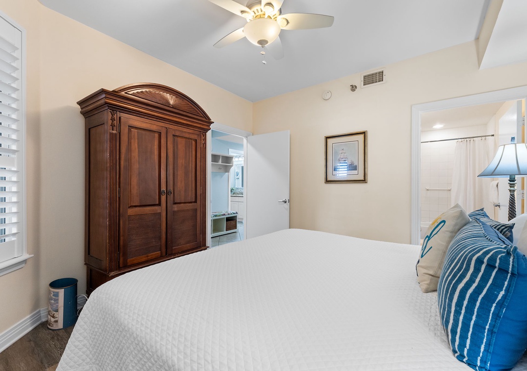 Beach Colony Tower 10C- Sink into your cozy retreat, where soft linens and vaulted ceilings invite restful nights. The elegant armoire provides ample space for your belongings, while cool air and gentle lighting ensure your complete comfort.