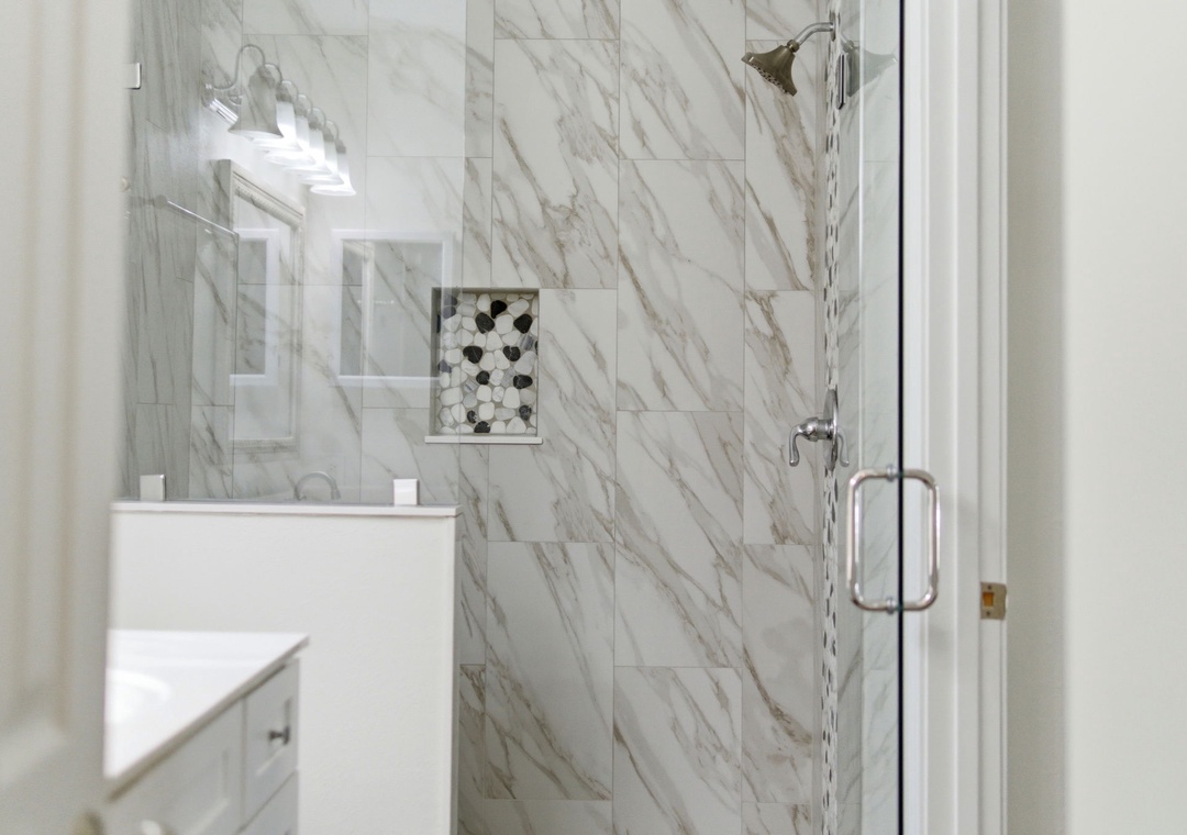 Grand Caribbean 305W- Elegant marble surrounds invite you to refresh in style, with a spacious walk-in shower and modern fixtures designed for your comfort.