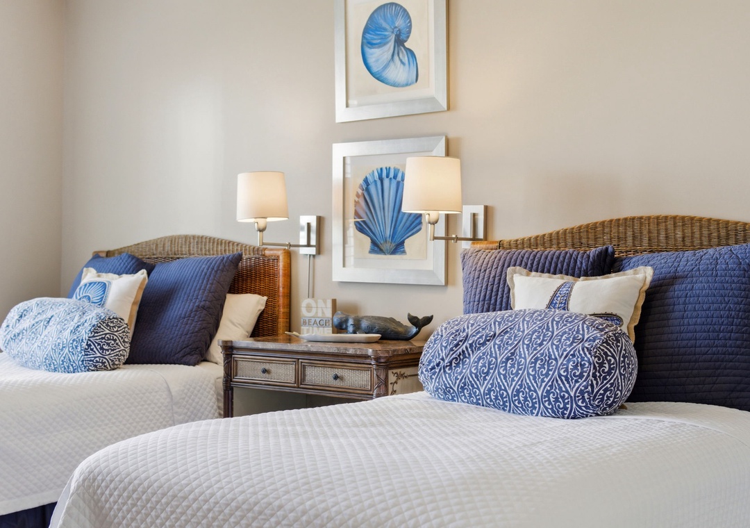 Beach Colony T PH1D-Drift off in this coastal-inspired bedroom with twin beds dressed in crisp linens and ocean-blue accents. Soft lighting and beach-themed art create your peaceful retreat.