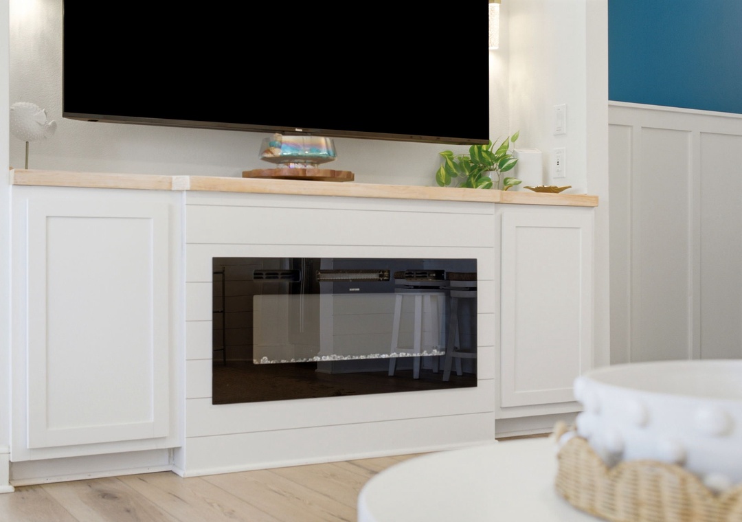 North Lost Key Landing B2- Unwind in your cozy living space with a warm fireplace and flat-screen TV, perfect for relaxing evenings after exploring the area.