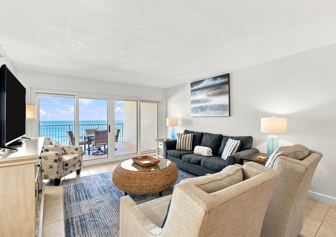 Sandy Key 411- Step into your bright coastal haven where floor-to-ceiling windows frame stunning turquoise waters, inviting you to unwind in comfort and let the ocean breeze set the tone for your getaway.