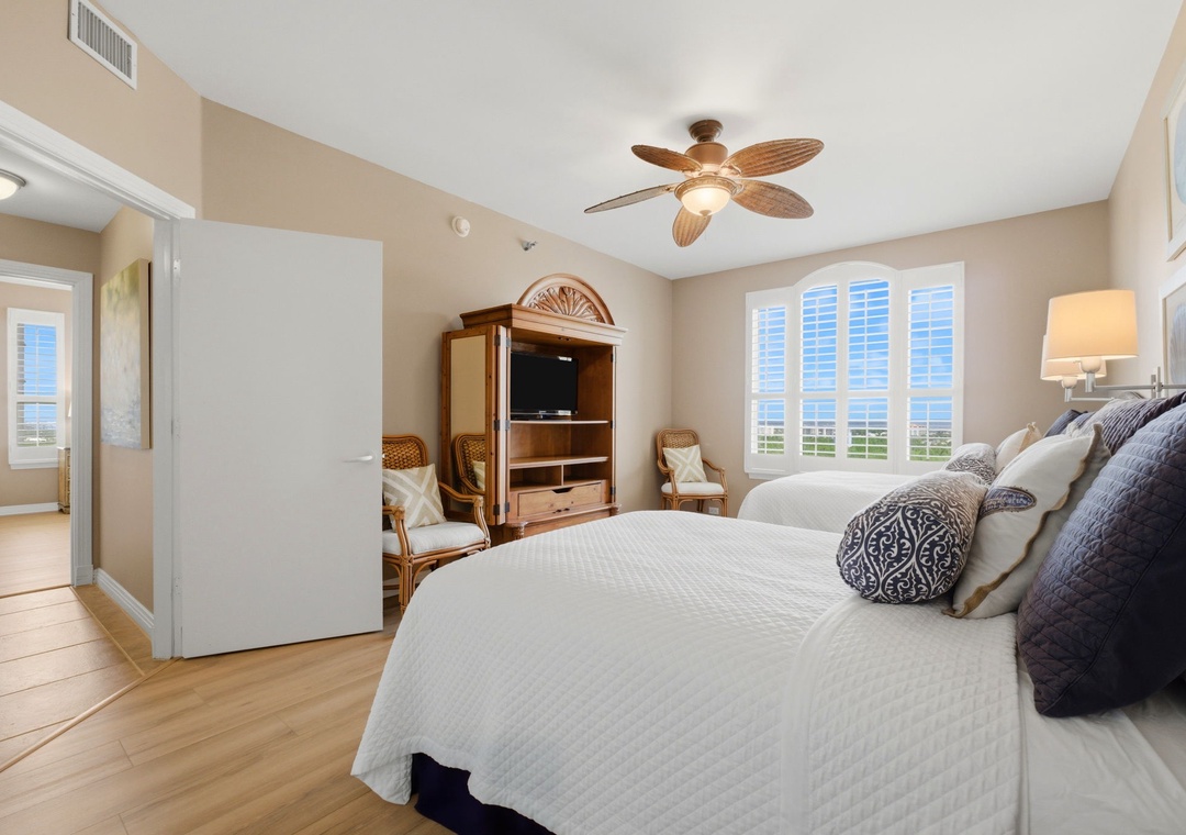 Beach Colony T PH1D-Sink into plush bedding and enjoy coastal views framed by plantation shutters. Your private retreat features a ceiling fan and en-suite bath for ultimate comfort.