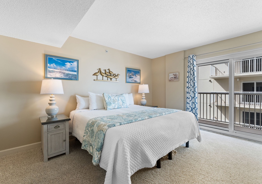 Sandy Key 628- Sink into coastal comfort with your plush king bed dressed in soft aqua linens, and wake to warm natural light streaming through your private balcony doors.