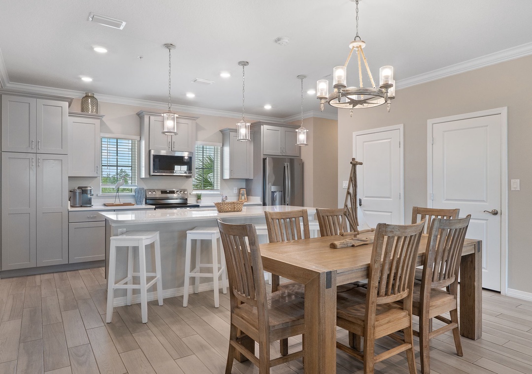 Saltwater & Sunsets- You'll love gathering around this warm farmhouse dining table, perfectly positioned next to your fully-equipped chef's kitchen with a spacious island for morning coffee and casual meals.