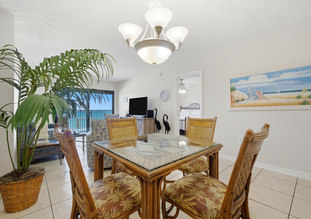 Ocean Breeze E702- Step into your open dining and living area with coastal decor, tropical palms, and stunning sea views through your private balcony. Perfect for meals with ocean breezes.