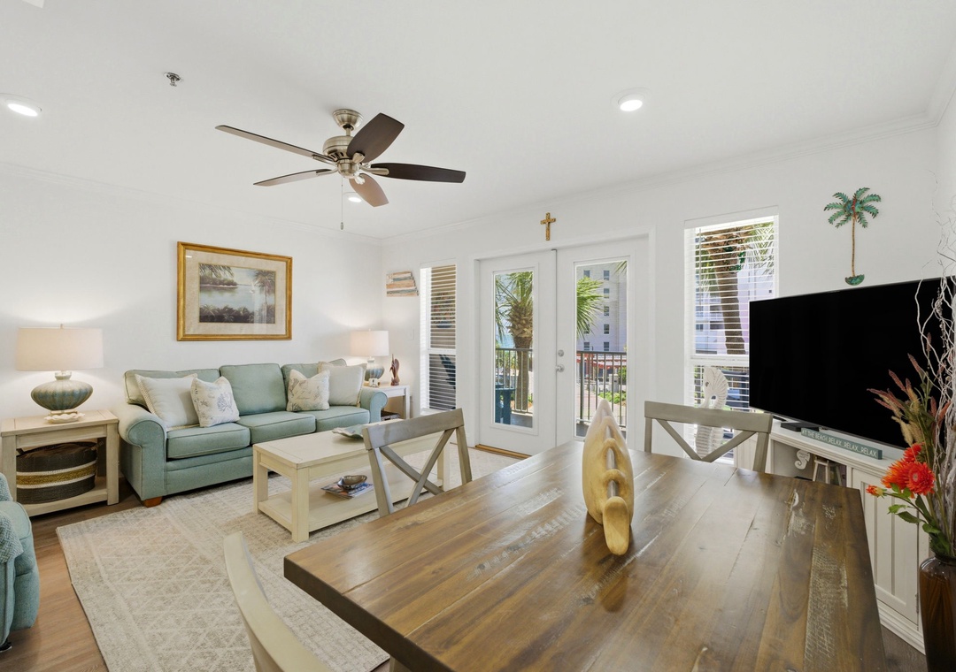 Grand Caribbean 305W- Relax in your bright, coastal-styled living room with ceiling fan, comfortable seating, and French doors opening to your private balcony with ocean views.