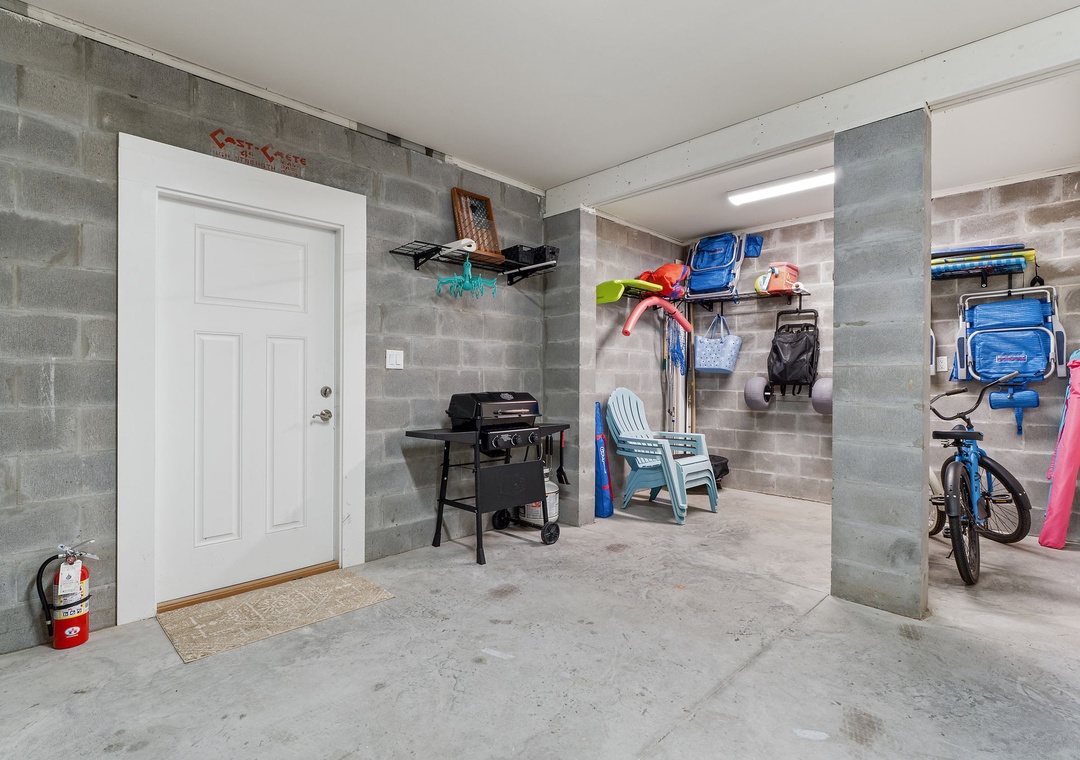 Turtles Nest- A spacious covered parking area with organized storage for beach gear, bikes, and outdoor equipment, plus a grill ready for cookouts.