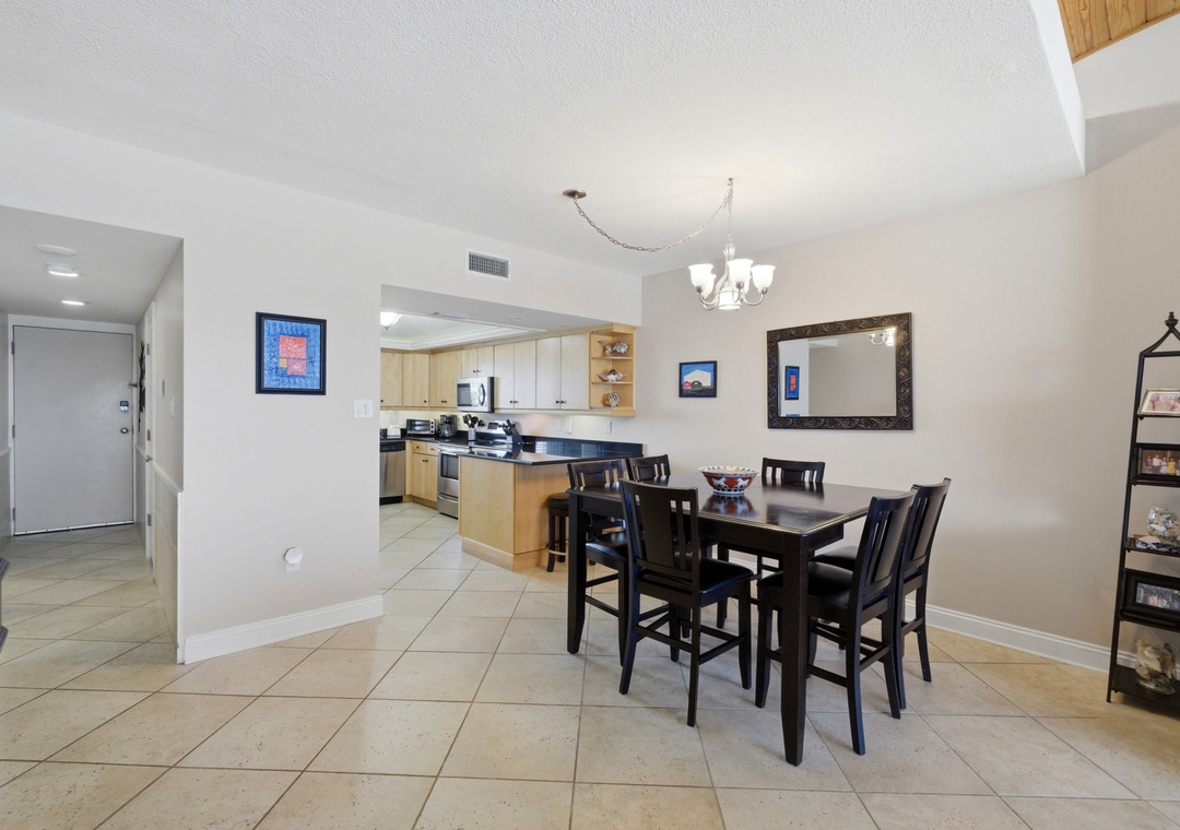 Shipwatch D803- A bright, open-plan space where your kitchen flows into the dining area, perfect for preparing and enjoying meals together. The elegant chandelier and thoughtful decor create a welcoming atmosphere for your vacation dining moments.