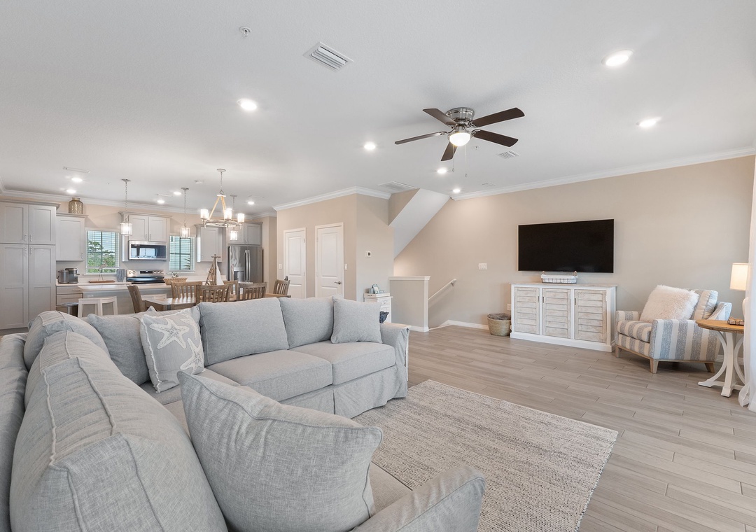 Saltwater & Sunsets- Sink into plush coastal comfort in this bright, open-plan living space where soft blues and creamy neutrals invite you to truly unwind and feel at home.